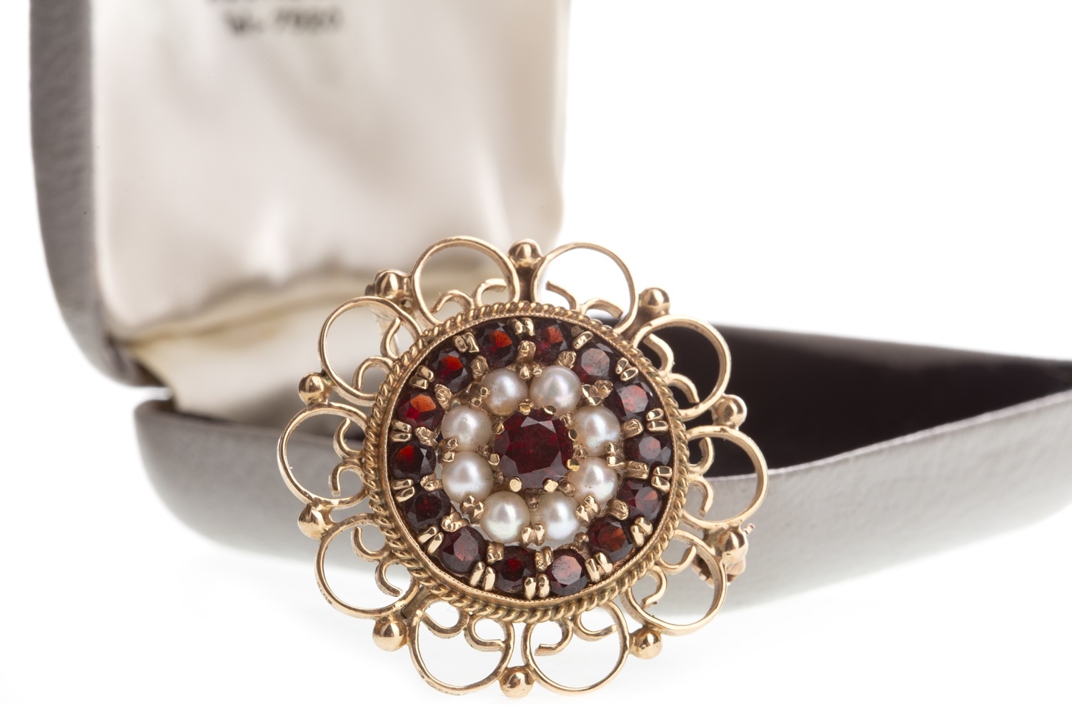 A RED GEM SET AND SEED PEARL BROOCH