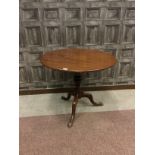 A MAHOGANY CIRCULAR TILT TOP TEA TABLE