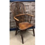 AN EARLY 19TH YEW, OAK AND ELM HIGH BACK WINDSOR ELBOW CHAIR