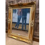 A REPRODUCTION VICTORIAN STYLE GILT FRAMED WALL MIRROR