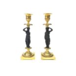 A PAIR OF 19TH CENTURY CAST METAL AND BRASS FIGURAL CANDLESTICKS