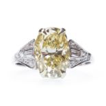 A GIA CERTIFICATED FANCY LIGHT YELLOW DIAMOND RING