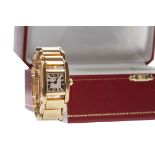 A LADY'S GOLD CARTIER TANK WRIST WATCH