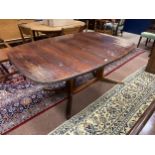 A RETRO ROSEWOOD EXTENDING DINING TABLE