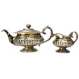 A GEORGE III SILVER TEAPOT AND CREAMER