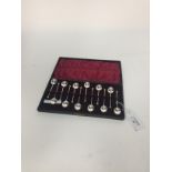 A CASED SET OF TWELVE SILVER SEAL TOP COFFEE SPOONS