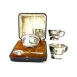 A CASED EARLY 20TH CENTURY PORRINGER SET ALONG WITH THREE SILVER CUPS