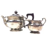 AN EARLY 20TH CENTURY SILVER TEAPOT AND CREAMER