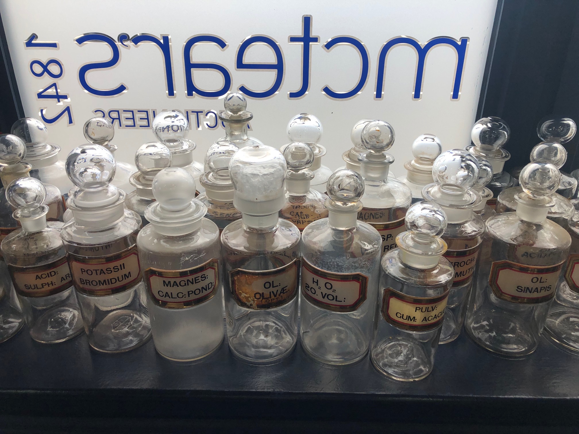 A LOT OF EARLY 20TH CENTURY CLEAR GLASS PHARMACEUTICAL BOTTLES