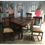 AN OAK DRAW LEAF DINING TABLE AND FOUR CHAIRS