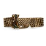 A GOLD BRACELET WITH GREEN GEM SET CLASP