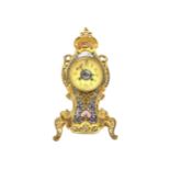 A VICTORIAN BRASS AND CHAMPLEVE ENAMEL CLOCK