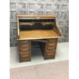 AN EDWARDIAN OAK DOUBLE PEDESTAL ROLL TOP DESK