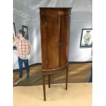 A GEORGE III MAHOGANY BOWFRONT CORNER CUPBOARD