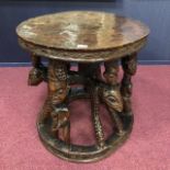 AN AFRICAN CARVED WOOD CEREMONIAL TABLE