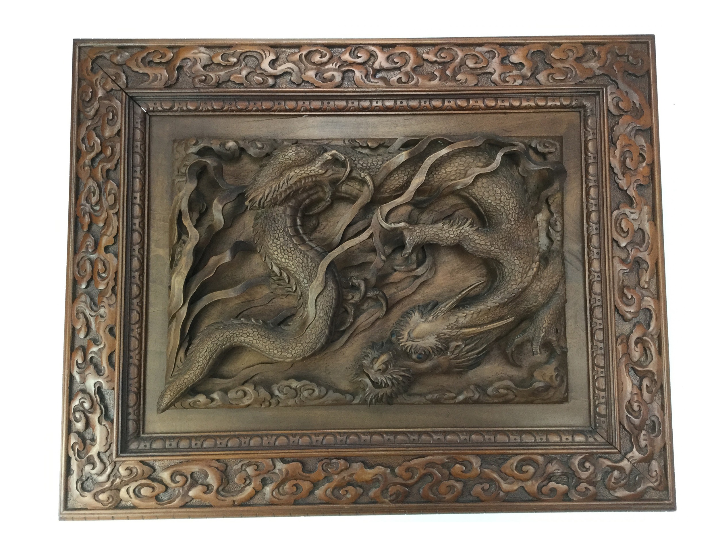 A CHINESE CARVED WOOD PANEL