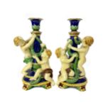 A PAIR OF MINTON MAJOLICA FIGURAL CANDLESTICKS