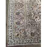 A HAND-KNOTTED PERSIAN CARPET