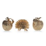 A NINE CARAT GOLD HEDGEHOG AND TWO APPLE CHARMS