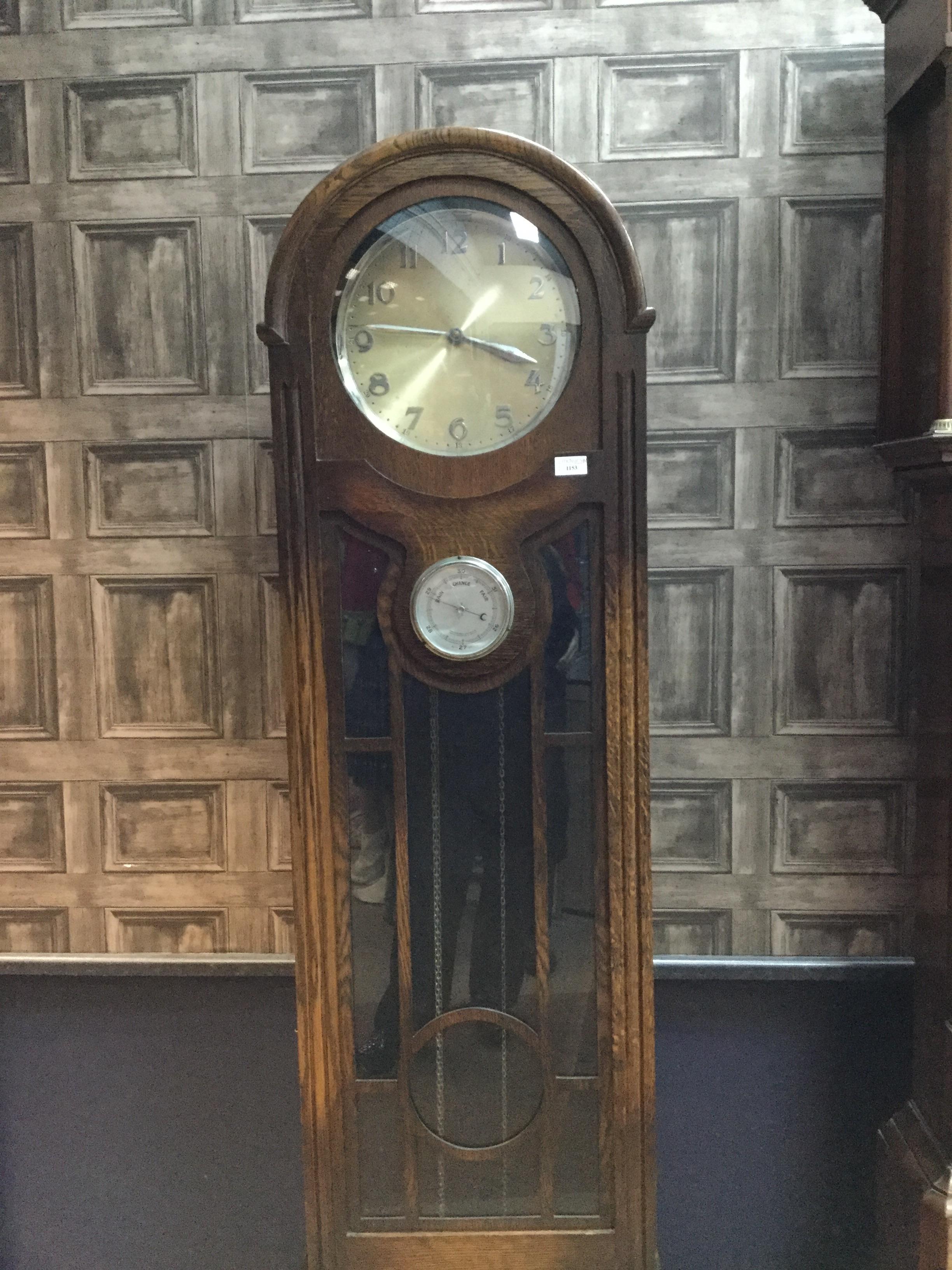 AN EARLY 20TH CENTURY OAK LONGCASE CLOCK