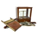 A SET OF CHEMIST'S SCALES BY OERTLING OF LONDON ALONG WITH ASSORTED MOULDS