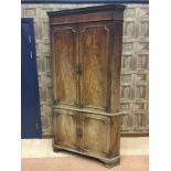 A REGENCY MAHOGANY TWO STAGE CORNER CUPBOARD