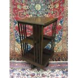 A 20TH CENTURY INLAID MAHOGANY REVOLVING BOOKCASE