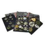 A COLLECTION OF METAL CAP BADGES AND OTHER INSIGNIA