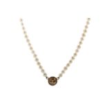 A FAUX PEARL NECKLACE WITH GOLD MOON CHARM