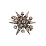 A DIAMOND SET STAR BROOCH