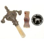 A MOTHER OF PEARL HANDLED SILVER RATTLE, SILVER AND ENAMEL BADGE AND AGATE SEAL