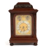 AN EDWARDIAN CARVED MAHOGANY BASKET TOPPED MANTEL CLOCK WITH TWIN FUSEE GONG STRIKING MOVEMENT,