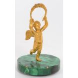A GILT BRONZE STATUETTE OF PUTTO ON MALACHITE VENEERED BASE, 14CM H, EARLY 19TH C, INCOMPLETE