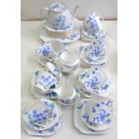 A COLCLOUGH BONE CHINA TEA SERVICE, ART DECO BLUE FLOWERS PATTERN 4117 AND A COLCLOUGH EARTHENWARE