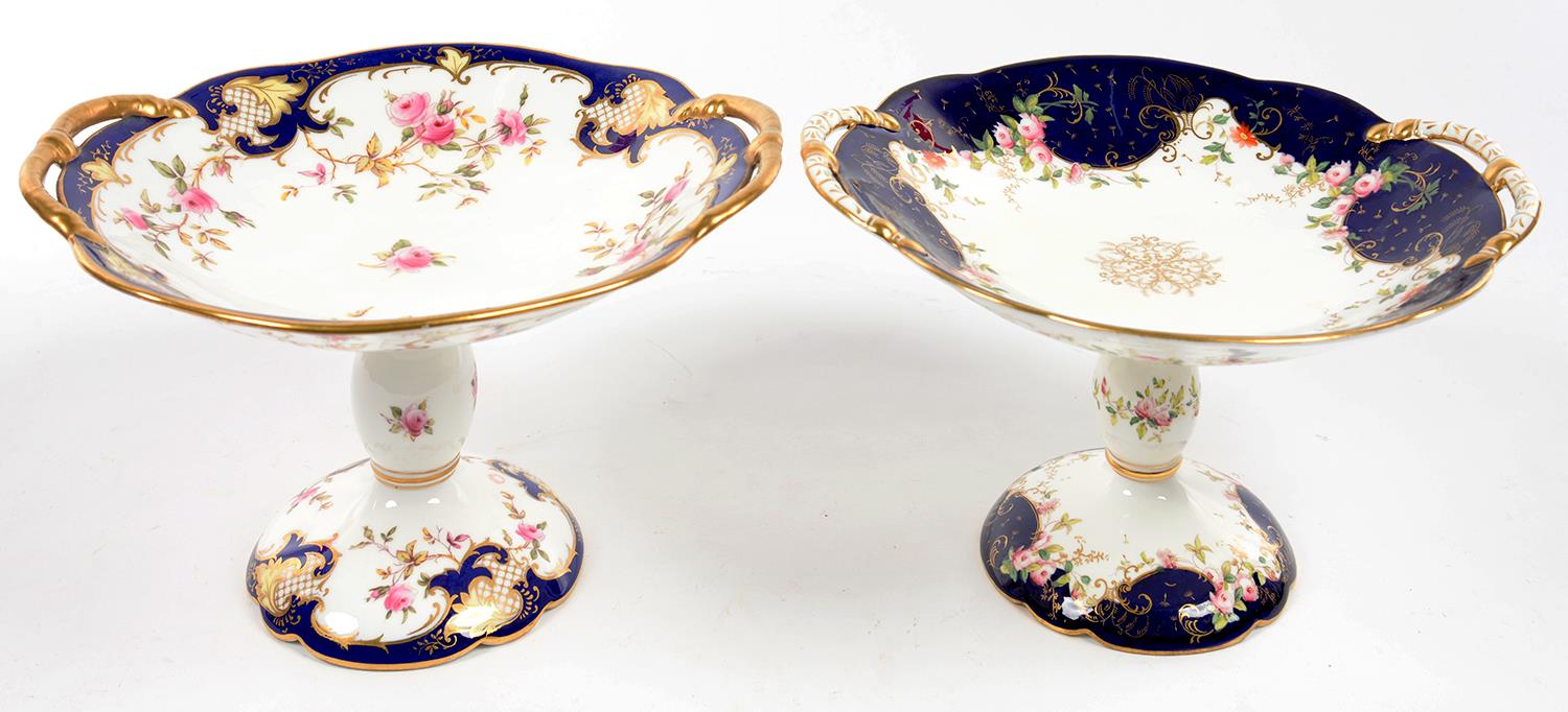 TWO COALPORT COBALT GROUND COMPORTS, DECORATED WITH ROSES, 24CM OVER HANDLES, PRINTED MARK, LATE