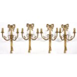 A SET OF FOUR LOUIS XVI STYLE BRASS TWIN BRANCH WALL LIGHTS OF RIBBON BOW AND TWIN TASSEL DESIGN,