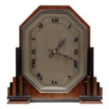 AN ENGLISH ART DECO WALNUT AND EBONISED MANTEL TIMEPIECE WITH OCTAGONAL DIAL AND PIERCED BLUED STEEL