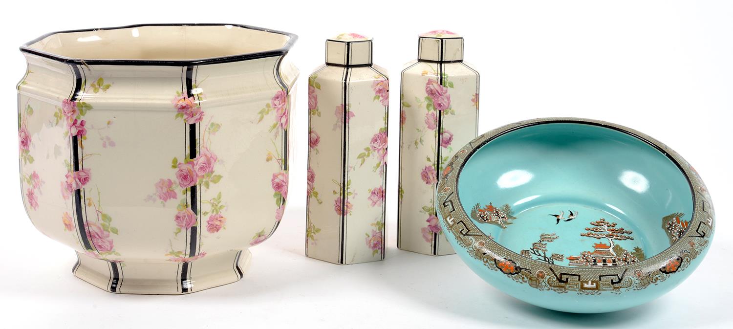 A ROYAL DOULTON OCTAGONAL EARTHENWARE JARDINIERE AND PAIR OF HEXAGONAL JARS AND COVERS EN SUITE,