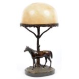 A BRONZE TABLE LAMP IN THE FORM OF A STALLION STANDING BEFORE A TREE, DOMED ALABASTER SHADE, ON