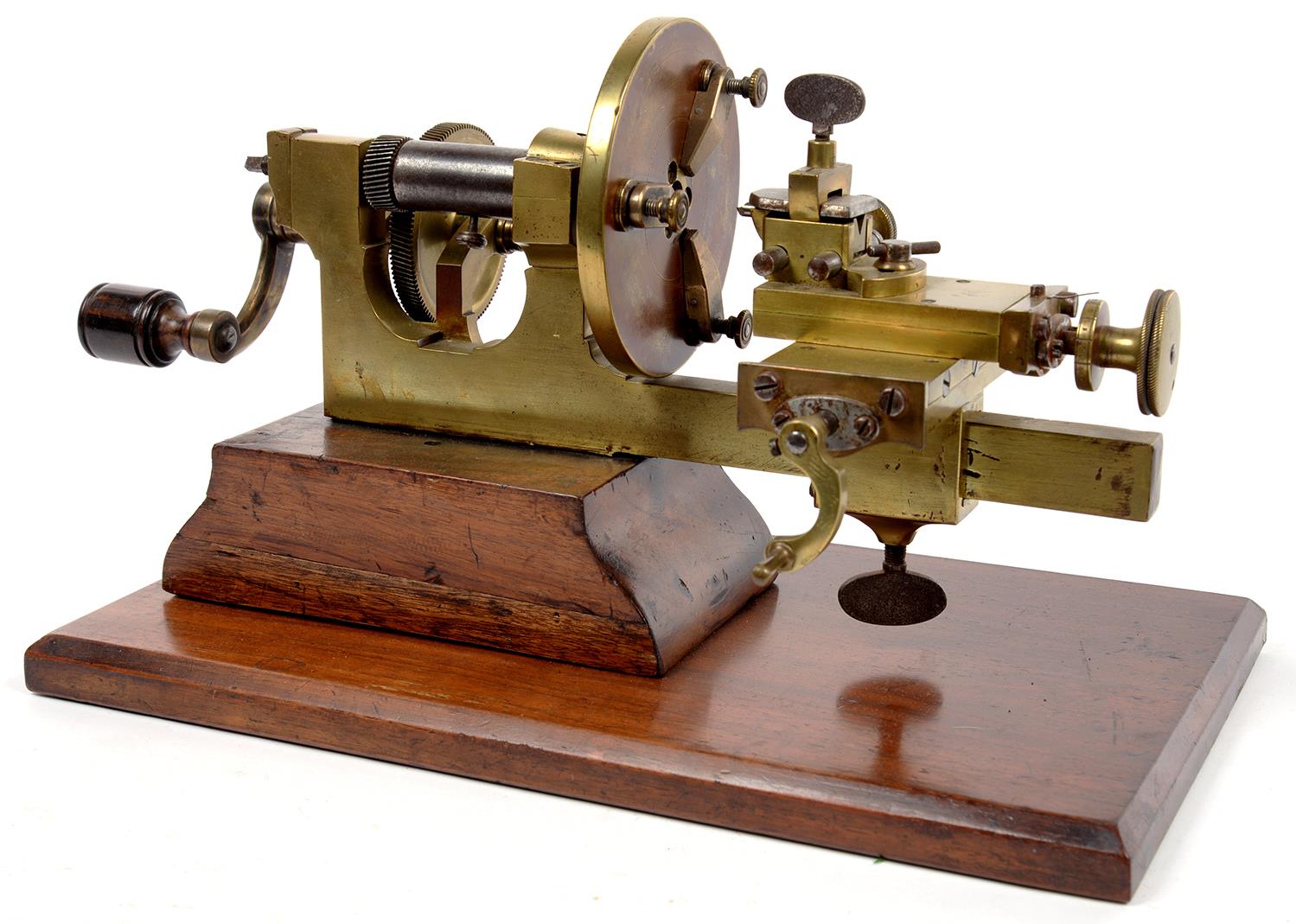 A VICTORIAN BRASS WATCHMAKER'S LATHE ON WALNUT BASE, 39CM L