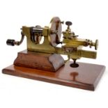 A VICTORIAN BRASS WATCHMAKER'S LATHE ON WALNUT BASE, 39CM L