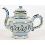 A FRENCH FAIENCE TEAPOT AND COVER, PAINTED IN COBALT AND BLACK WITH A BAND OF STYLISED LEAVES, 12.