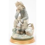 A LLADRO FIGURE OF A SEATED GIRL WITH A DOLL, 22CM H, PRINTED MARK