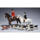 A BESWICK FOX HUNTER (LADY) AND A SIMILAR FIGURE (MAN) AND SIX HOUNDS, MAN 25CM H, PRINTED MARK OR