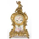 A FRENCH GILTMETAL AND PORCELAIN INSET MANTEL CLOCK IN LOUIS XV STYLE, SURMOUNTED BY THE SEATED