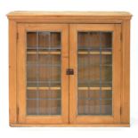 A VICTORIAN WAXED PINE BOOKCASE WITH LEADED GLASS DOORS, 104CM H X 111CM W