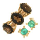 A PAIR OF STEP CUT EMERALD STUD EARRINGS IN GOLD MARKED 9CT AND A GARNET THREE STONE RING IN 9CT