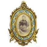 A FRENCH OVAL ORMOLU AND CHAMPLEVE ENAMEL PHOTOGRAPH FRAME, APPLIED WITH PUTTI, 26CM H, C1880