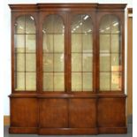 A WALNUT BREAKFRONT BOOKCASE IN GEORGE II STYLE WITH ADJUSTABLE GLASS SHELVES, 230CM H; 212 X 44CM