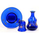 A BLUE AND GILT GLASS MINIATURE CARAFE, BEAKER AND STAND, 10.5CM D, C1900